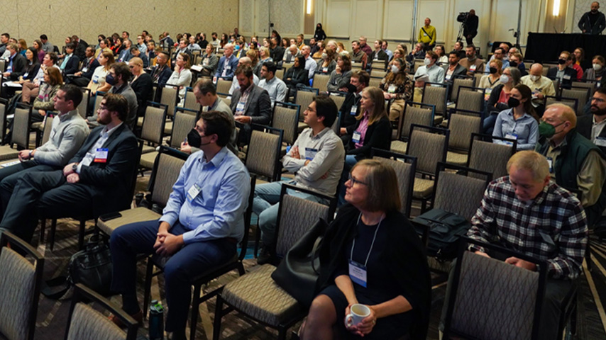 ACES attendees listen attentively to a speaker presentation
