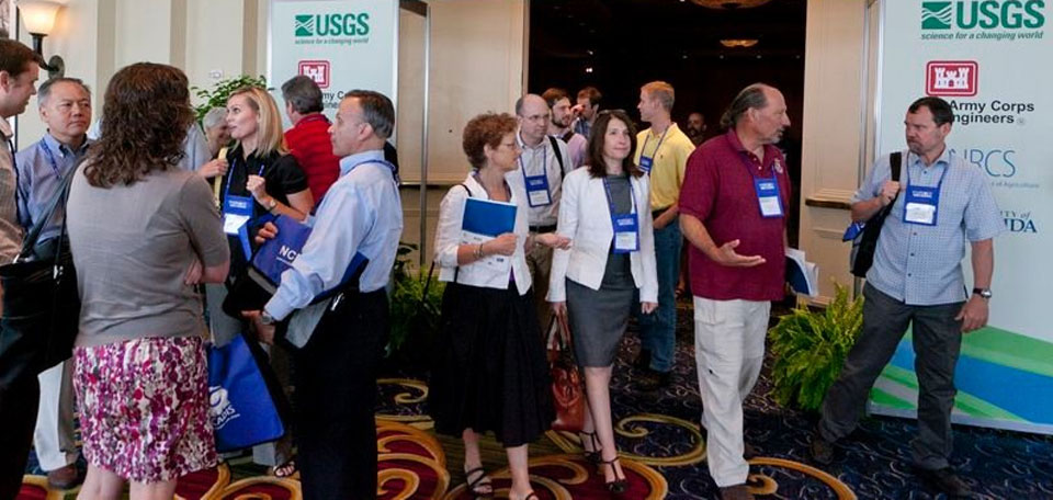 Attendees conversate at the entrace of an NCER conference.